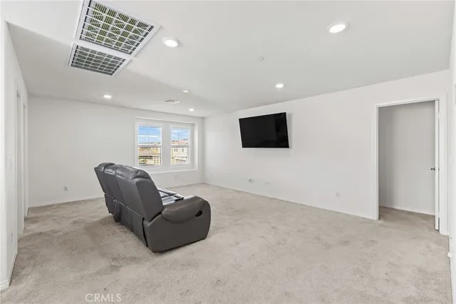 a living room with a couch and a dresser