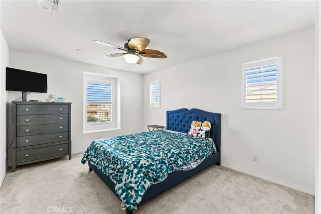 a bedroom with a bed and a television