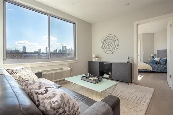 a living room with a bed furniture and a window