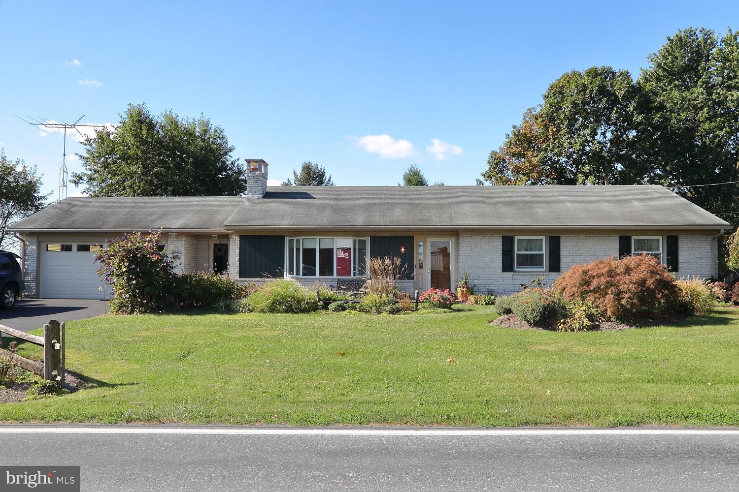 543 Hossler Road Manheim, PA 17545 - Photo 1 of 26 a front view of a house with a yard and garage