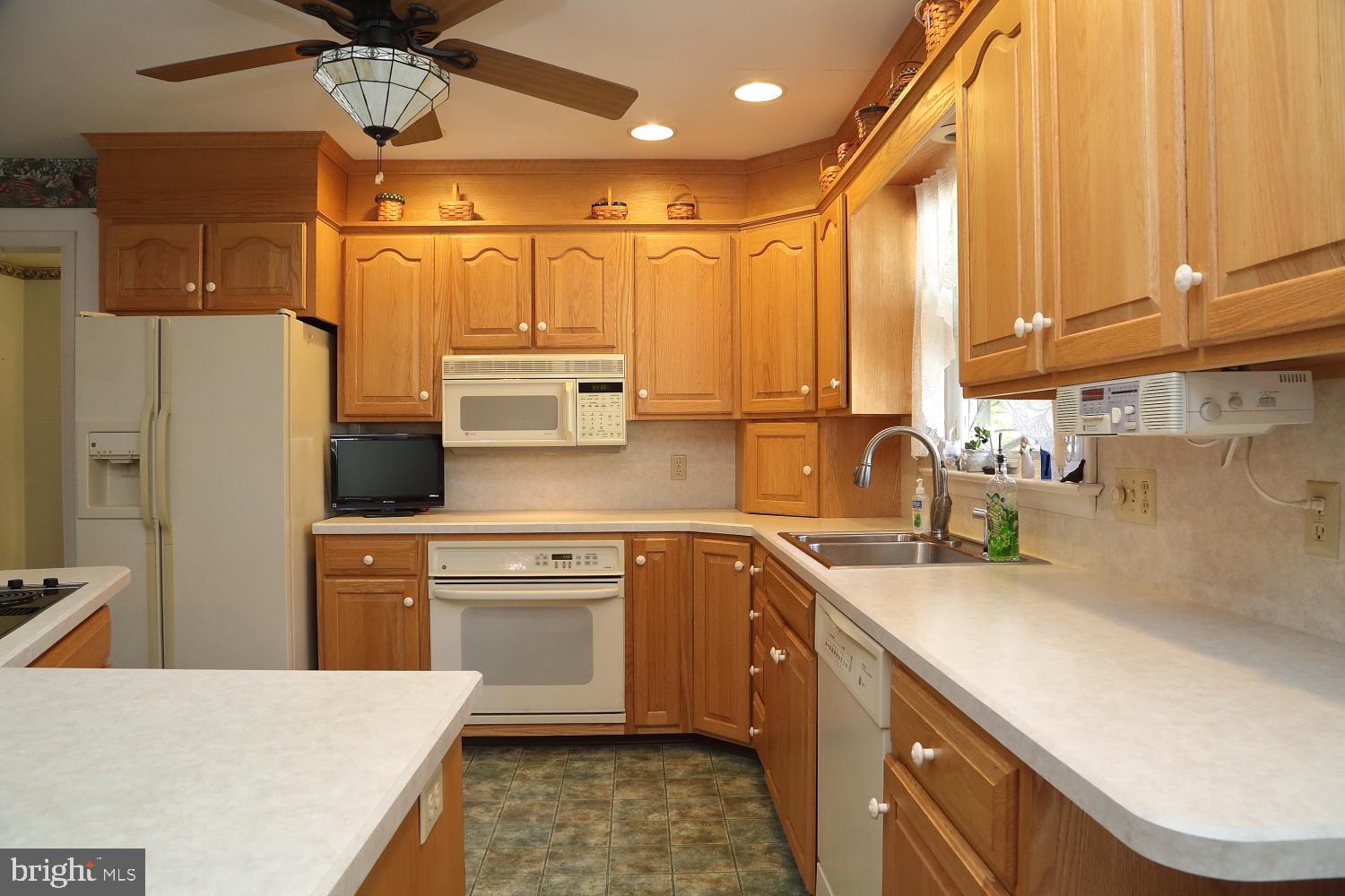 543 Hossler Road Manheim, PA 17545 - Photo 9 of 26 a kitchen with a sink a refrigerator and cabinets