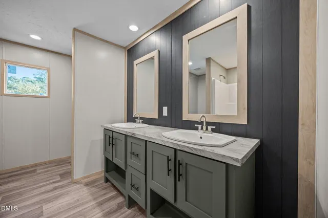a bathroom with a double vanity sink and a mirror
