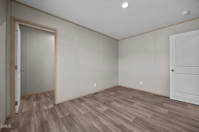 a view of room with wooden floor