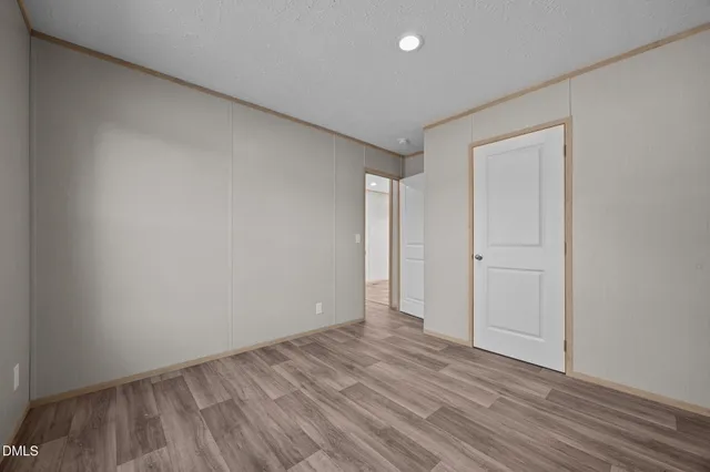 a view of an empty room and wooden floor