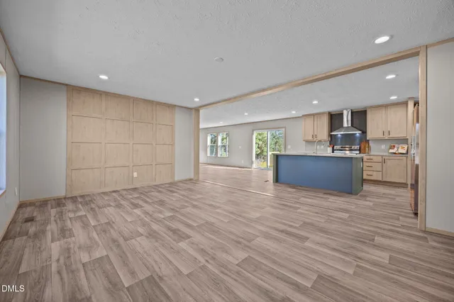 a view of an empty room with a cabinet and a window