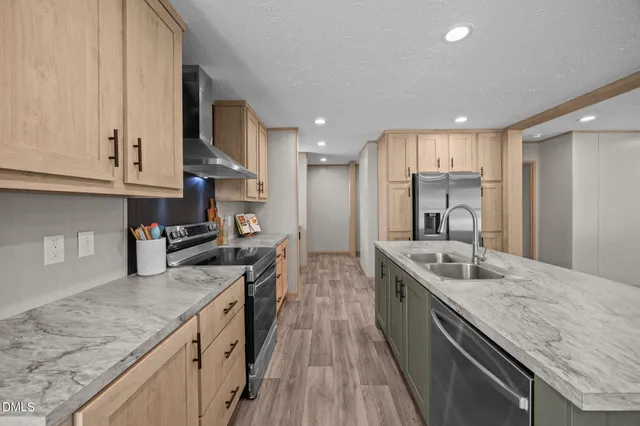 a kitchen with stainless steel appliances granite countertop a lot of counter space