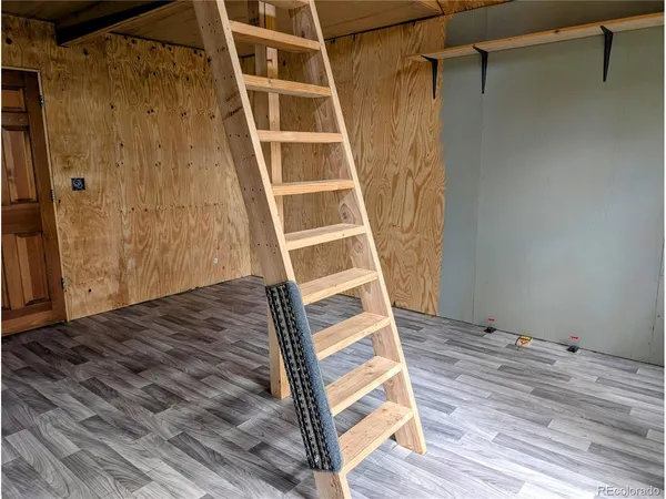 a view of balcony with wooden floor and seating space