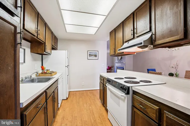 a kitchen with stainless steel appliances granite countertop a stove and a sink