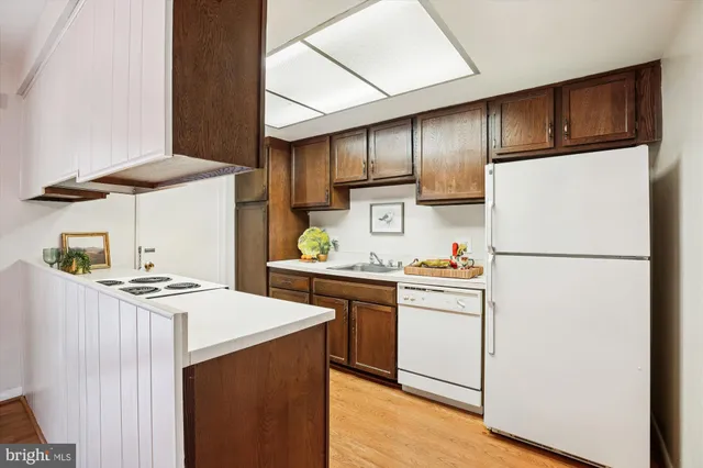 a kitchen with stainless steel appliances a refrigerator sink and stove