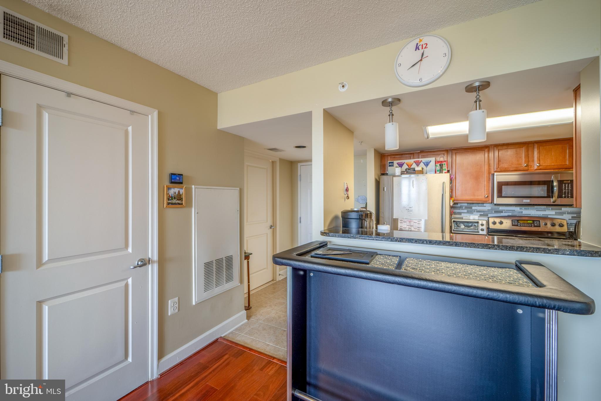 11800 Sunset Hills Road, Unit 925 Reston, VA 20190 - Photo 13 of 49 a kitchen with stainless steel appliances granite countertop a sink and a stove