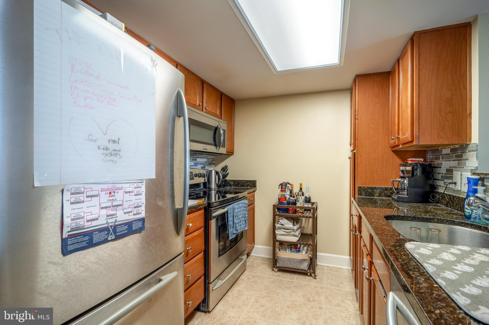 11800 Sunset Hills Road, Unit 925 Reston, VA 20190 - Photo 16 of 49 a kitchen with stainless steel appliances granite countertop a refrigerator and a stove top oven