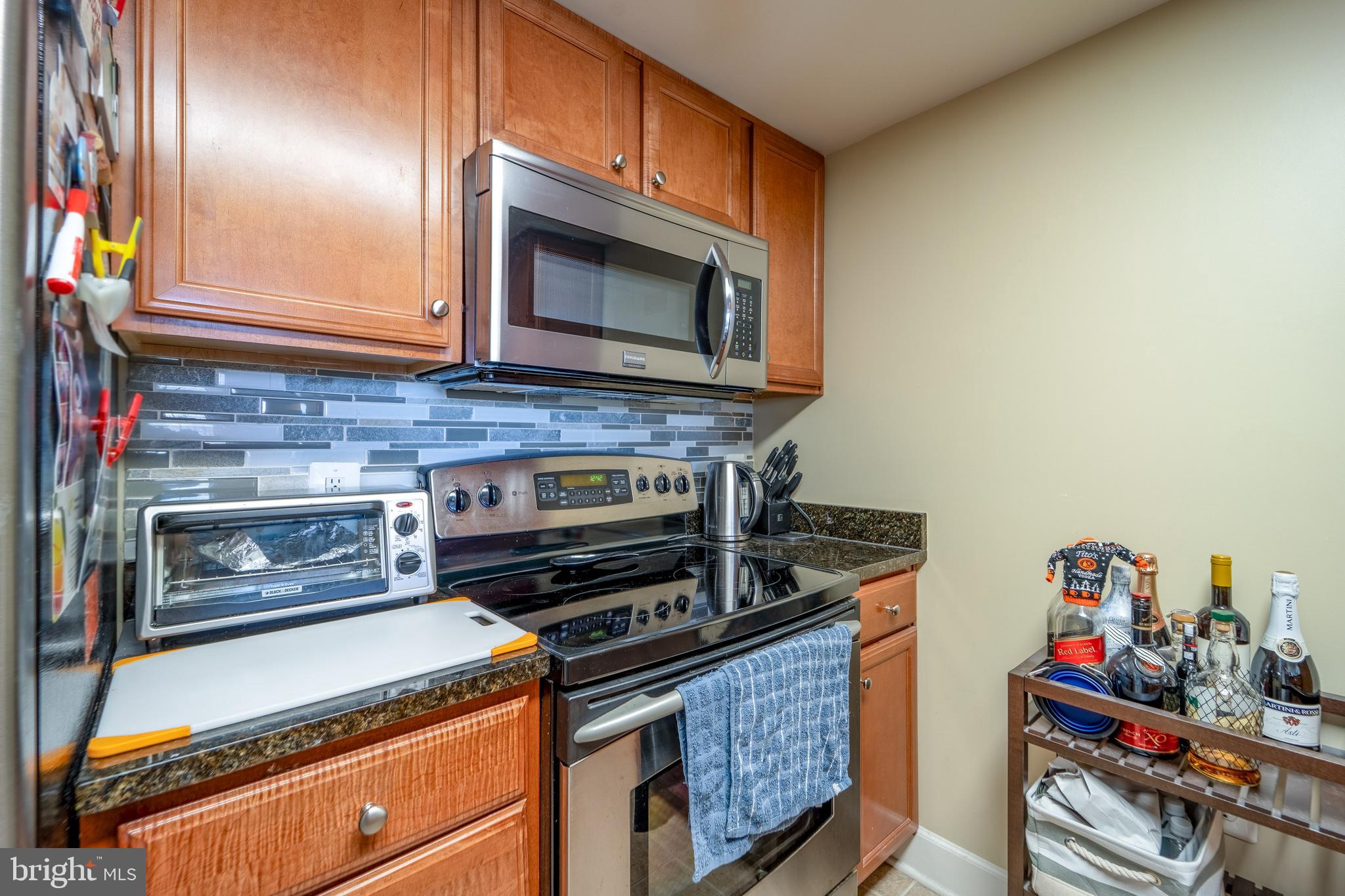 11800 Sunset Hills Road, Unit 925 Reston, VA 20190 - Photo 17 of 49 a kitchen with stainless steel appliances granite countertop a stove and a microwave