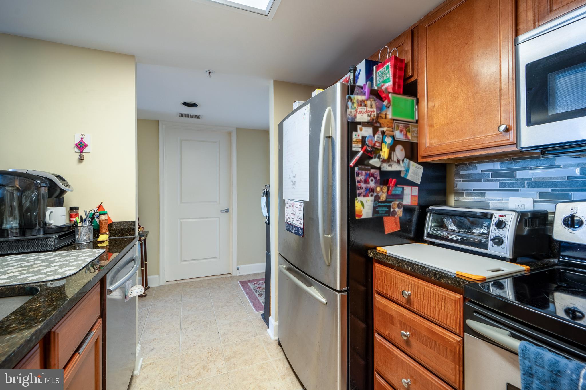 11800 Sunset Hills Road, Unit 925 Reston, VA 20190 - Photo 19 of 49 a kitchen with stainless steel appliances granite countertop a stove and a refrigerator