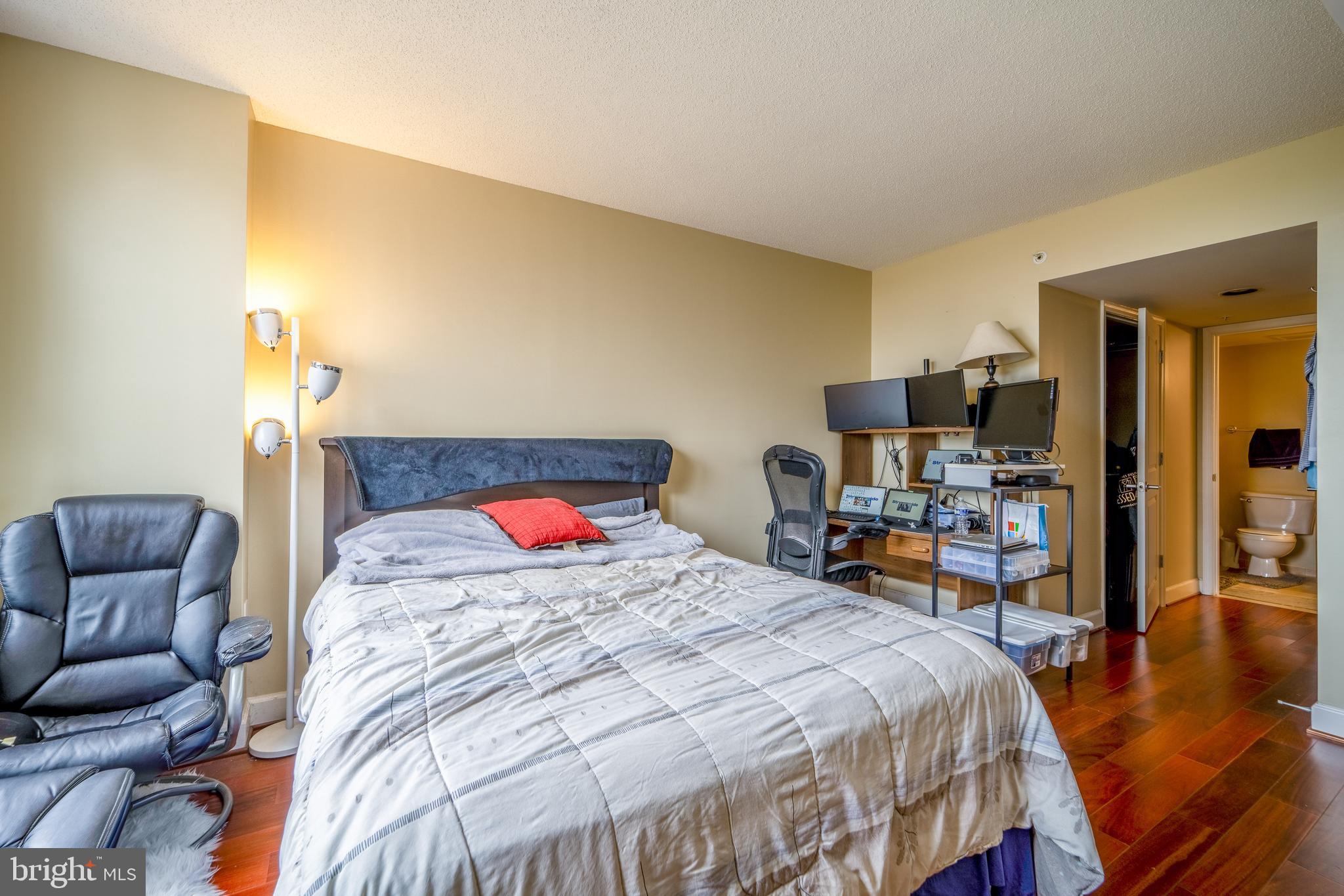 11800 Sunset Hills Road, Unit 925 Reston, VA 20190 - Photo 22 of 49 a bedroom with a bed and wooden floor