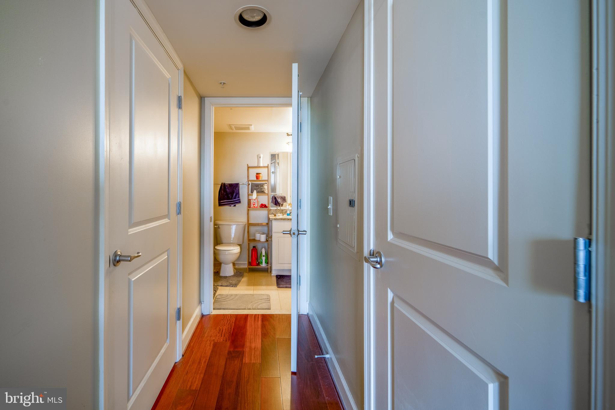 11800 Sunset Hills Road, Unit 925 Reston, VA 20190 - Photo 23 of 49 a view of a hallway with wooden floor and a bathroom