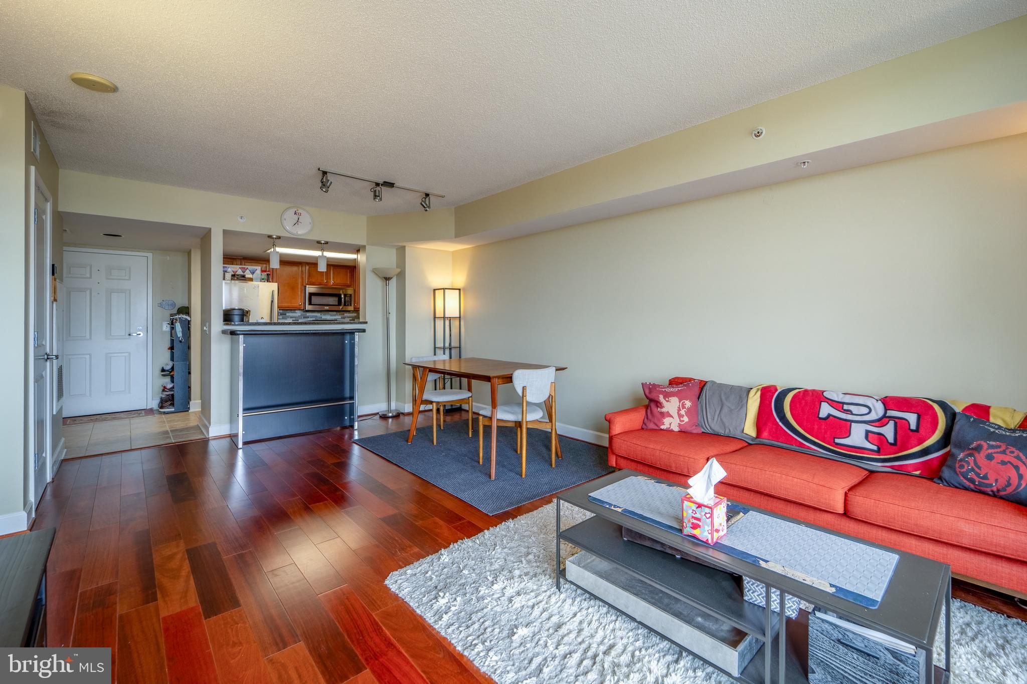 11800 Sunset Hills Road, Unit 925 Reston, VA 20190 - Photo 9 of 49 a living room with furniture kitchen view and a wooden floor