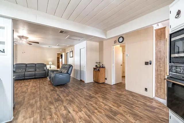 a view of living room filled with furniture and wooden floor