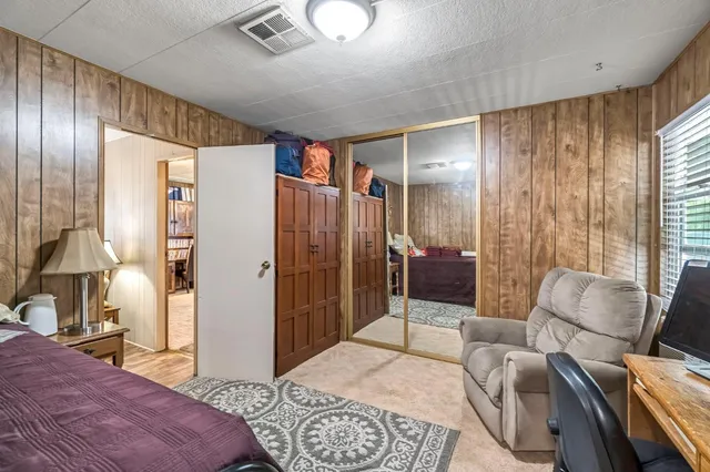 a bedroom with a bed couch and a dresser