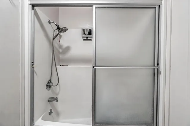 a bathroom with a glass shower door