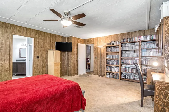a spacious bedroom with a bed and a large cabinets