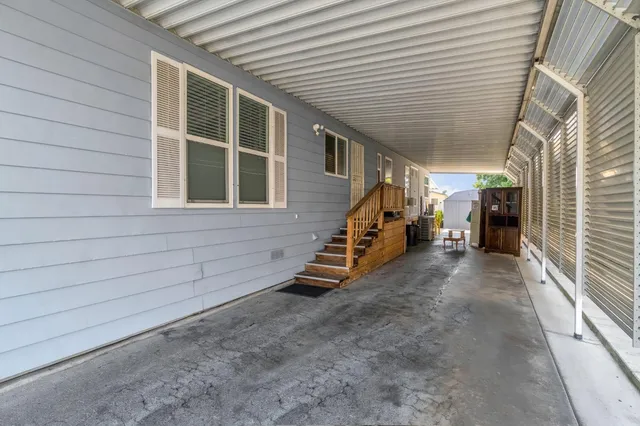 a view of a patio with table and chairs potted plants with wooden floor