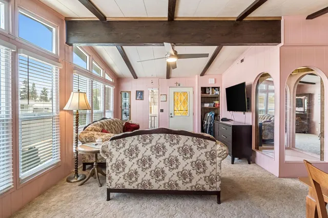 a bedroom with a bed next to a window with the outer view