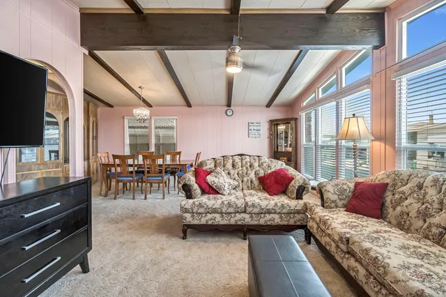 a bedroom with furniture and a flat screen tv