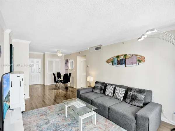 a living room with furniture and a flat screen tv