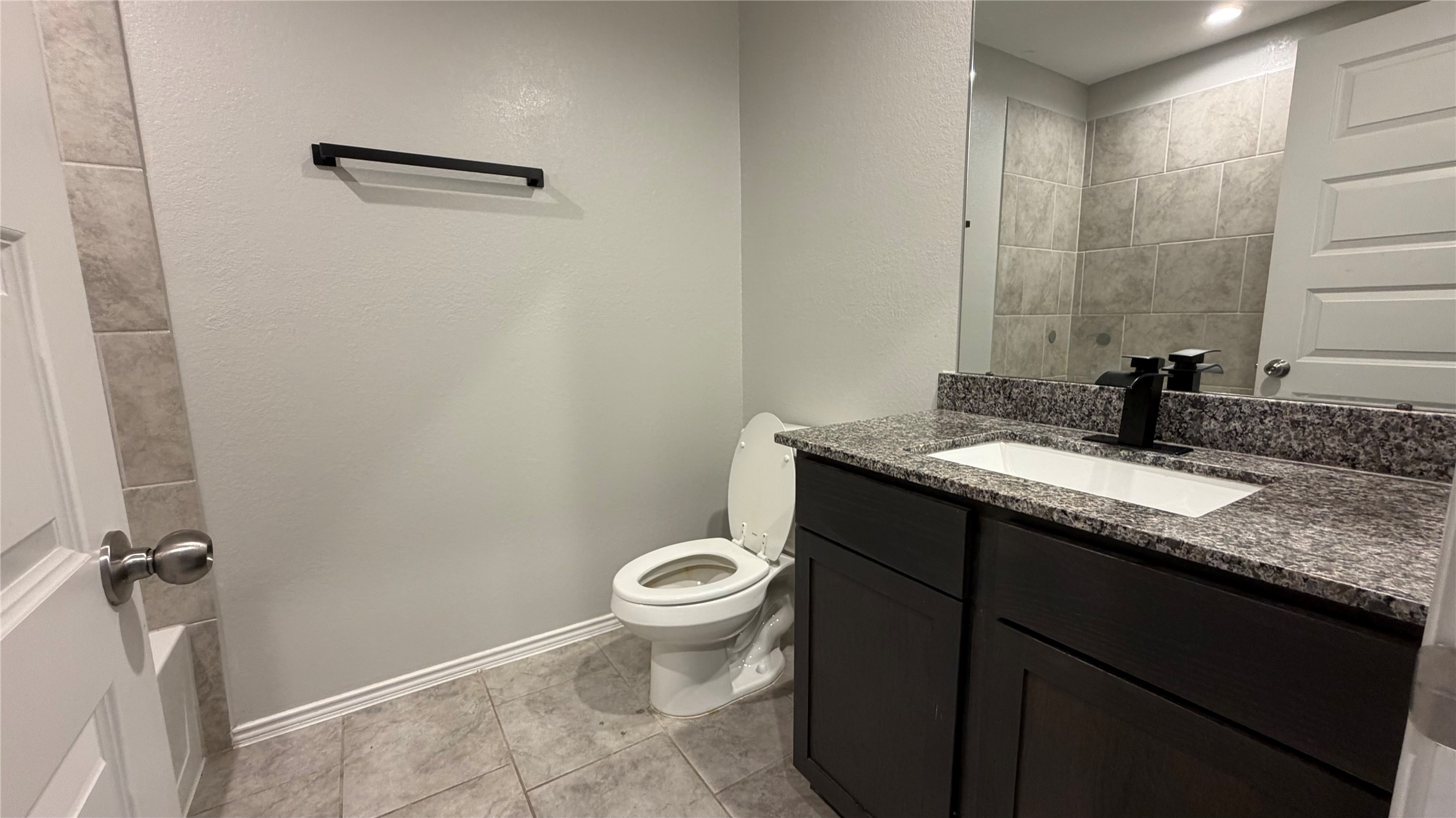 7518 Cynomys Court Rosharon, TX 77583 - Photo 13 of 21 a bathroom with a granite countertop sink toilet and shower