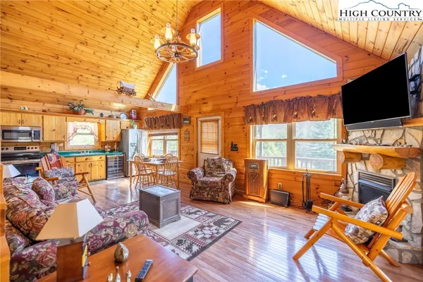 a view of a patio with couches chairs and wooden floor