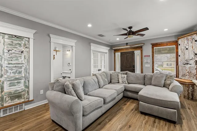 a living room with furniture and a large window
