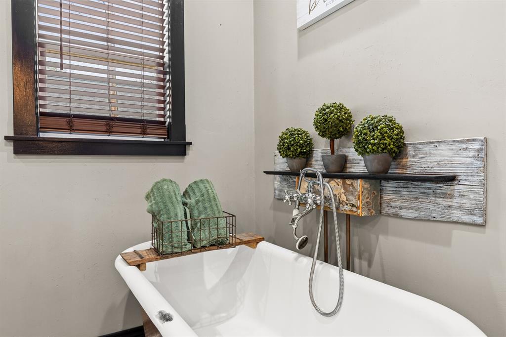 1815 South 12th Street Waco, TX 76706 - Photo 30 of 39 a bathroom with a granite countertop sink a mirror and vanity