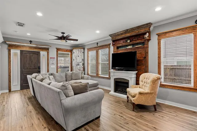 a living room with furniture fireplace and flat screen tv