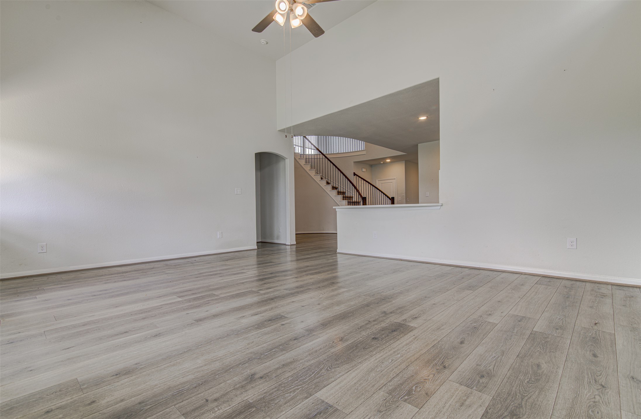 774 Cherrystone Loop Buda, TX 78610 - Photo 14 of 38 A spacious common area with soaring vaulted ceilings and sleek wood flooring offers an inviting entry.