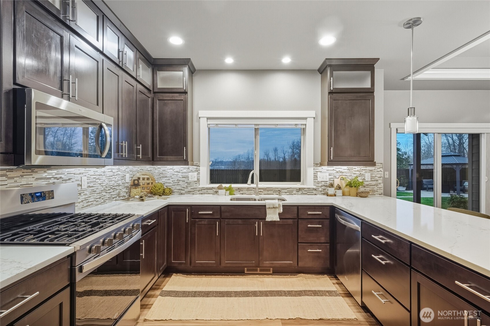 1476 Patriot Court Ferndale, WA 98248 - Photo 17 of 40 a kitchen with a stove sink and cabinets