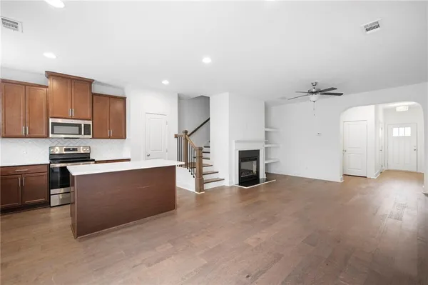 a view of kitchen with stainless steel appliances cabinets
