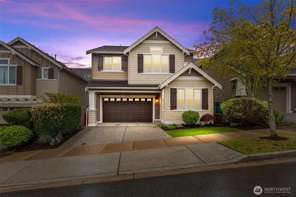 a front view of a house with a yard and garage