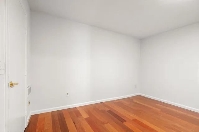a view of a room with wooden floor