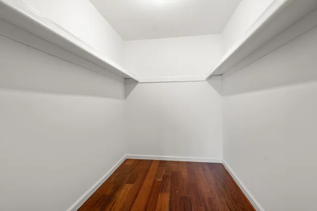 a view of an empty room and wooden floor