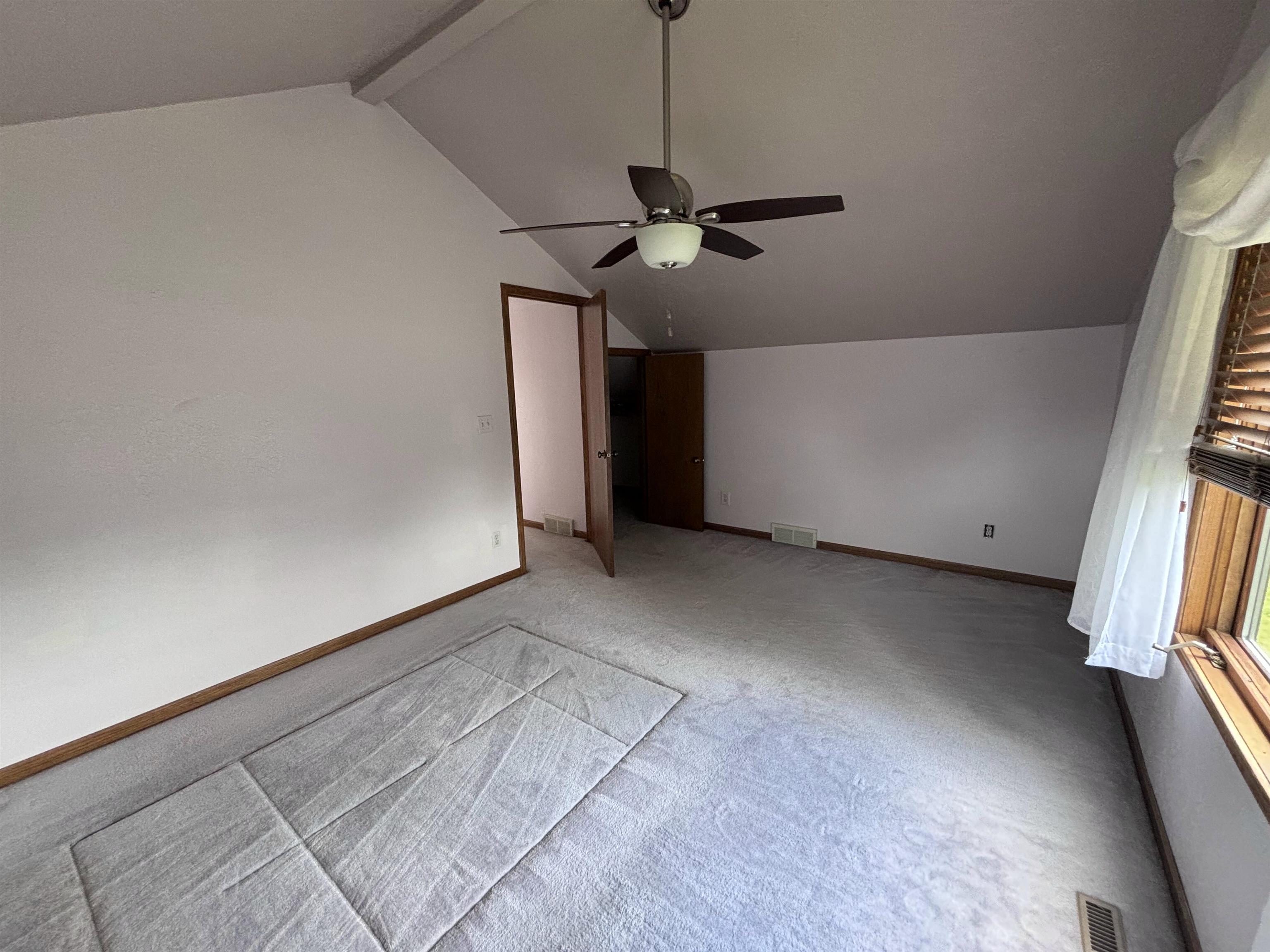 3543 Mill Road Cherry Valley, IL 61016 - Photo 18 of 46 a view of a livingroom with a ceiling fan and window