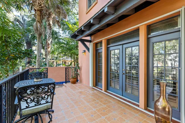 a view of a patio with a table and chairs and wooden fence