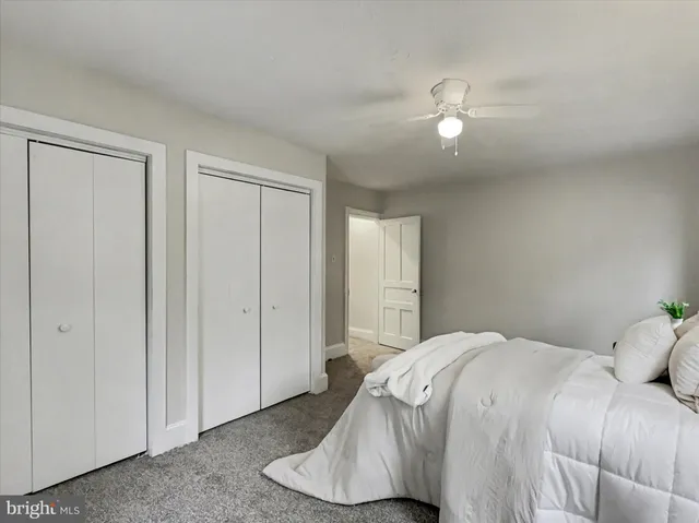 a bedroom with a bed and a lamp