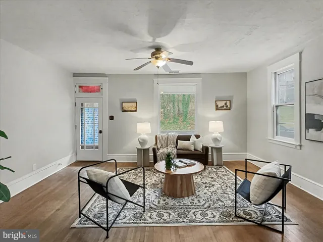 a living room with furniture a window and a chandelier