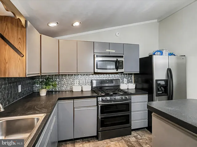 a kitchen with a refrigerator sink and stove