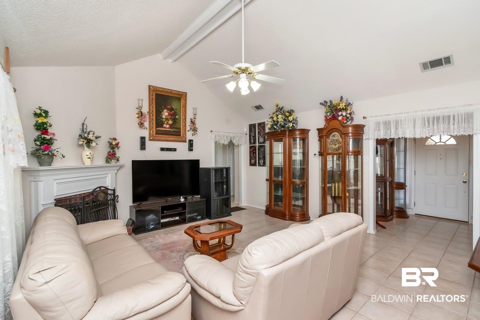 8221 Woodbend Drive Semmes, AL 36575 - Photo 8 of 35 Tiled living room featuring ceiling fan and vaulted ceiling with beams