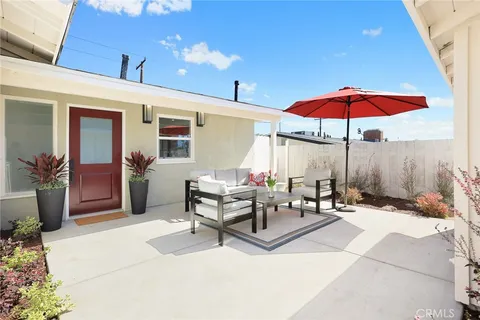 a outdoor space with patio the couches and chairs under an umbrella