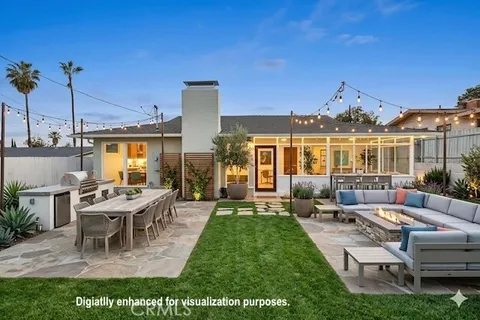 a view of a house with backyard sitting area and garden
