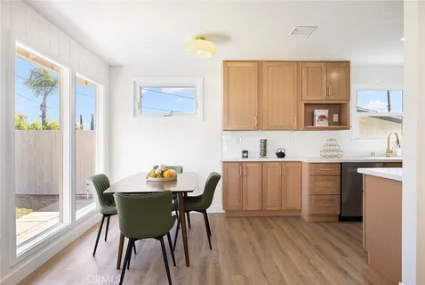 a kitchen with a table chairs and a sink