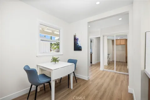 a dining room with furniture and wooden floor