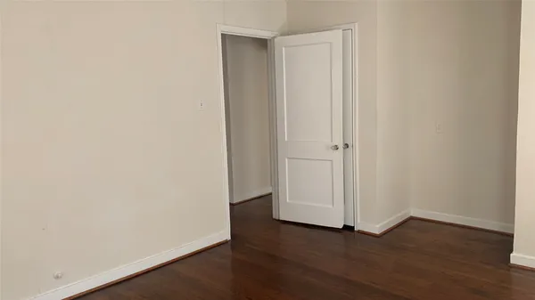 an empty room with wooden floor